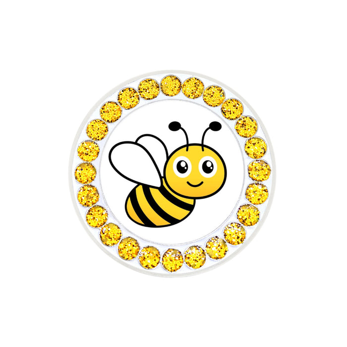 Round decorative item with a bee illustration and yellow gemstones on a white background