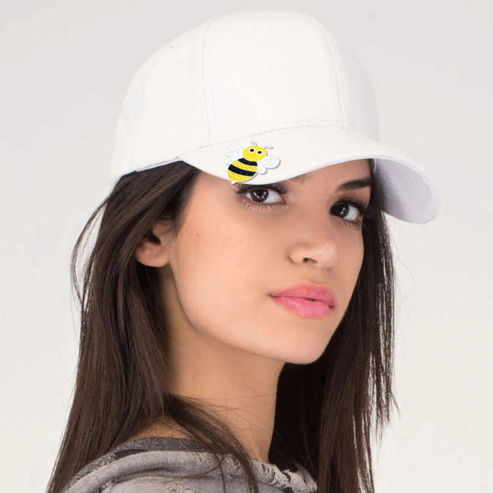 Woman wearing a white cap with a bumble bee with crystal wings