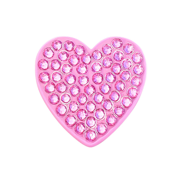 Pink heart-shaped object with embedded crystals on a white background